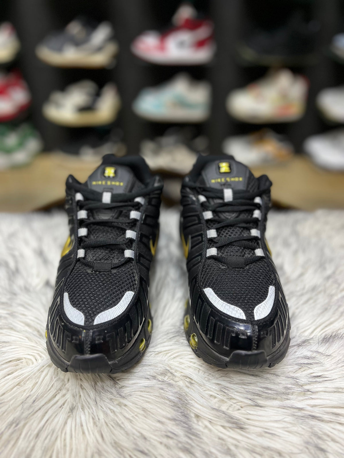 Black sneaker with a gold Nike swoosh