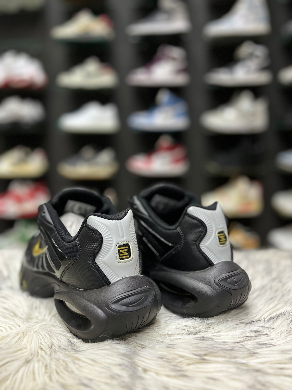 Black sneaker with a gold Nike swoosh