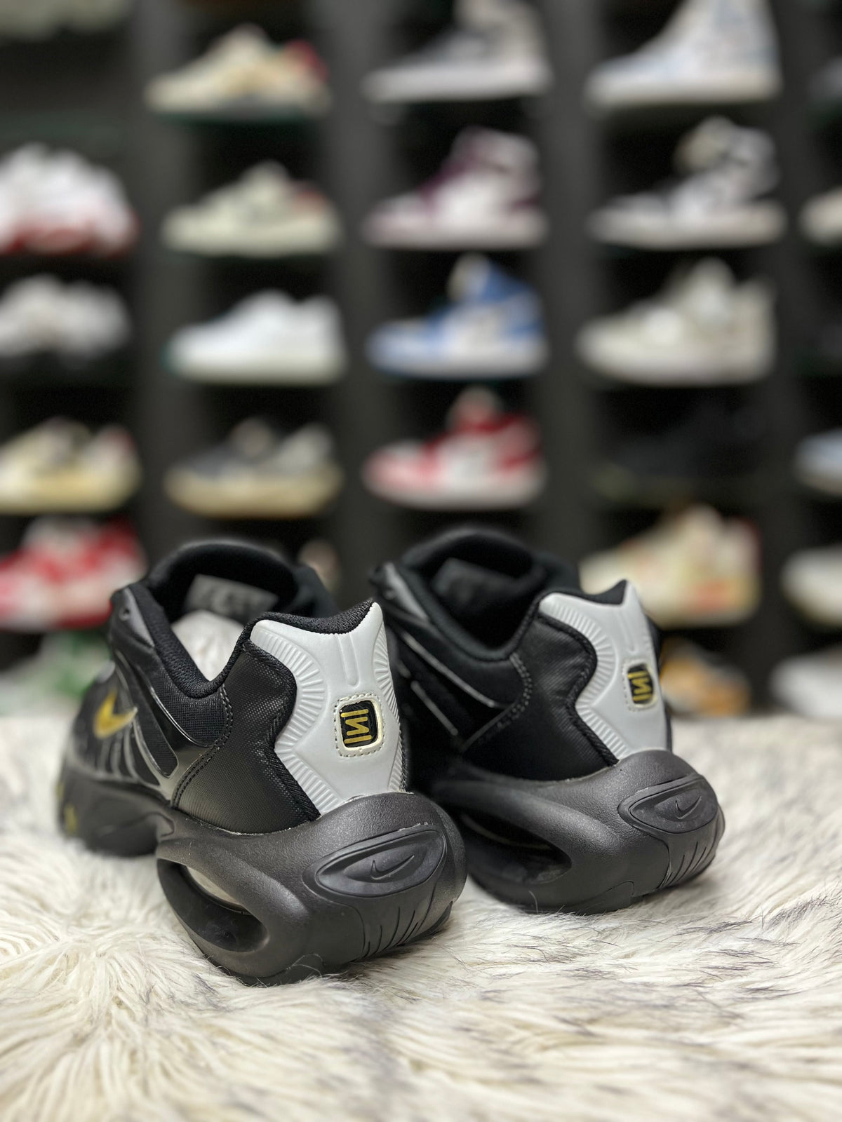 Black sneaker with a gold Nike swoosh