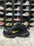 Black sneaker with a gold Nike swoosh