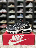Black and white Nike sneaker with a mesh and synthetic.