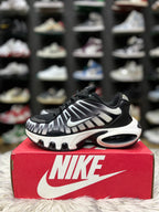Black and white Nike sneaker with a mesh and synthetic.