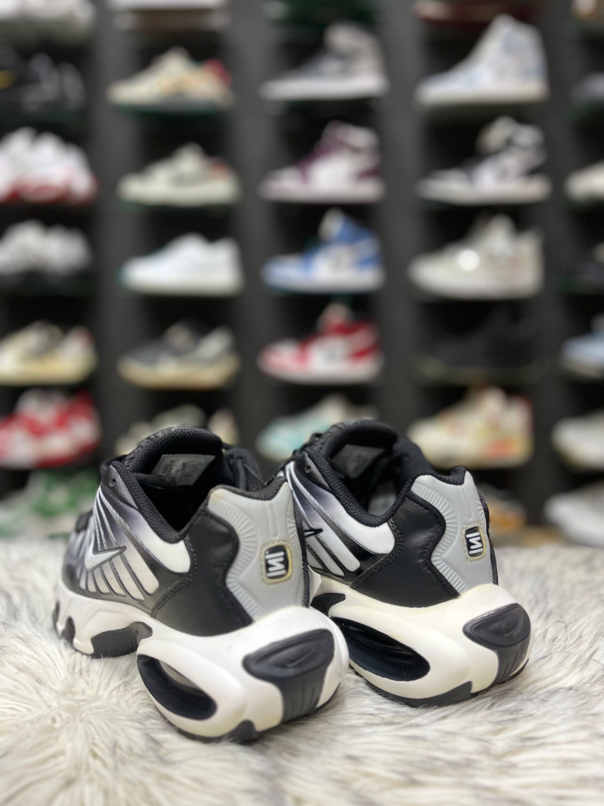 Black and white Nike sneaker with a mesh and synthetic.