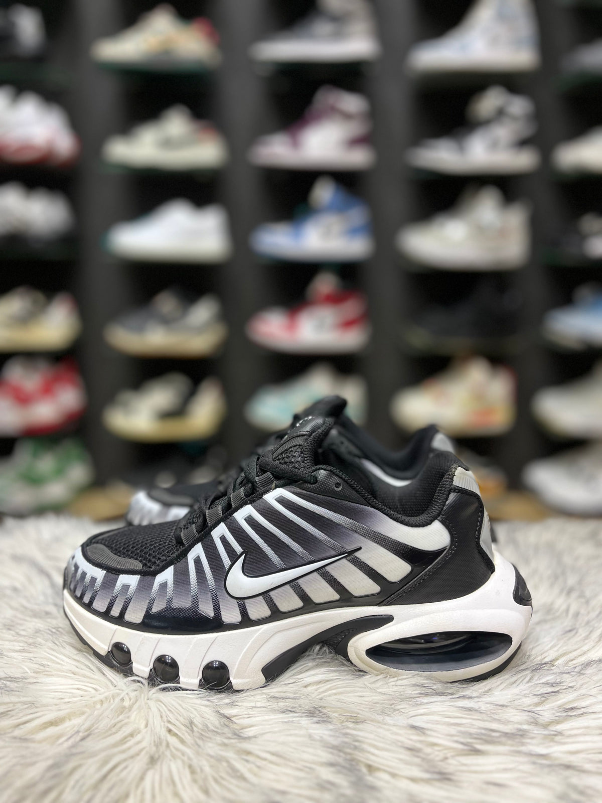 Black and white Nike sneaker with a mesh and synthetic.