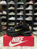 Black sneaker with a gold Nike swoosh