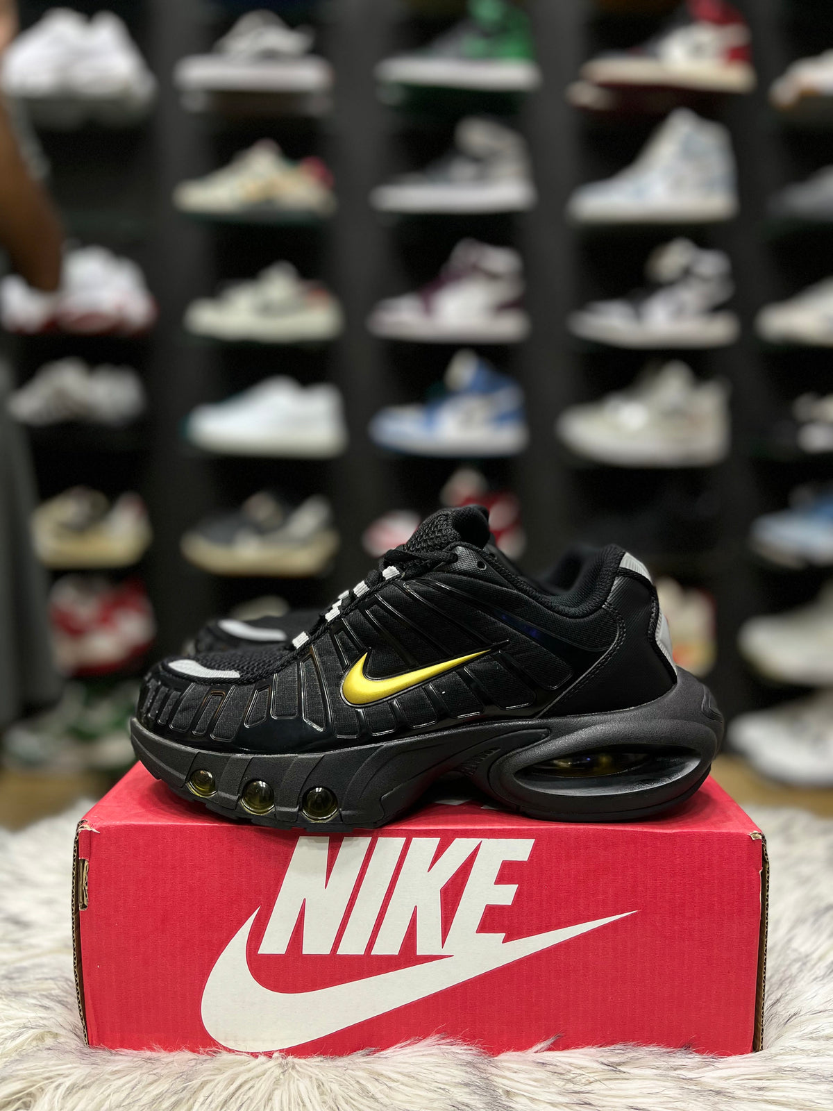 Black sneaker with a gold Nike swoosh