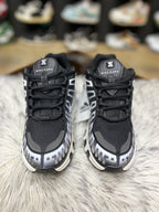 Black and white Nike sneaker with a mesh and synthetic.