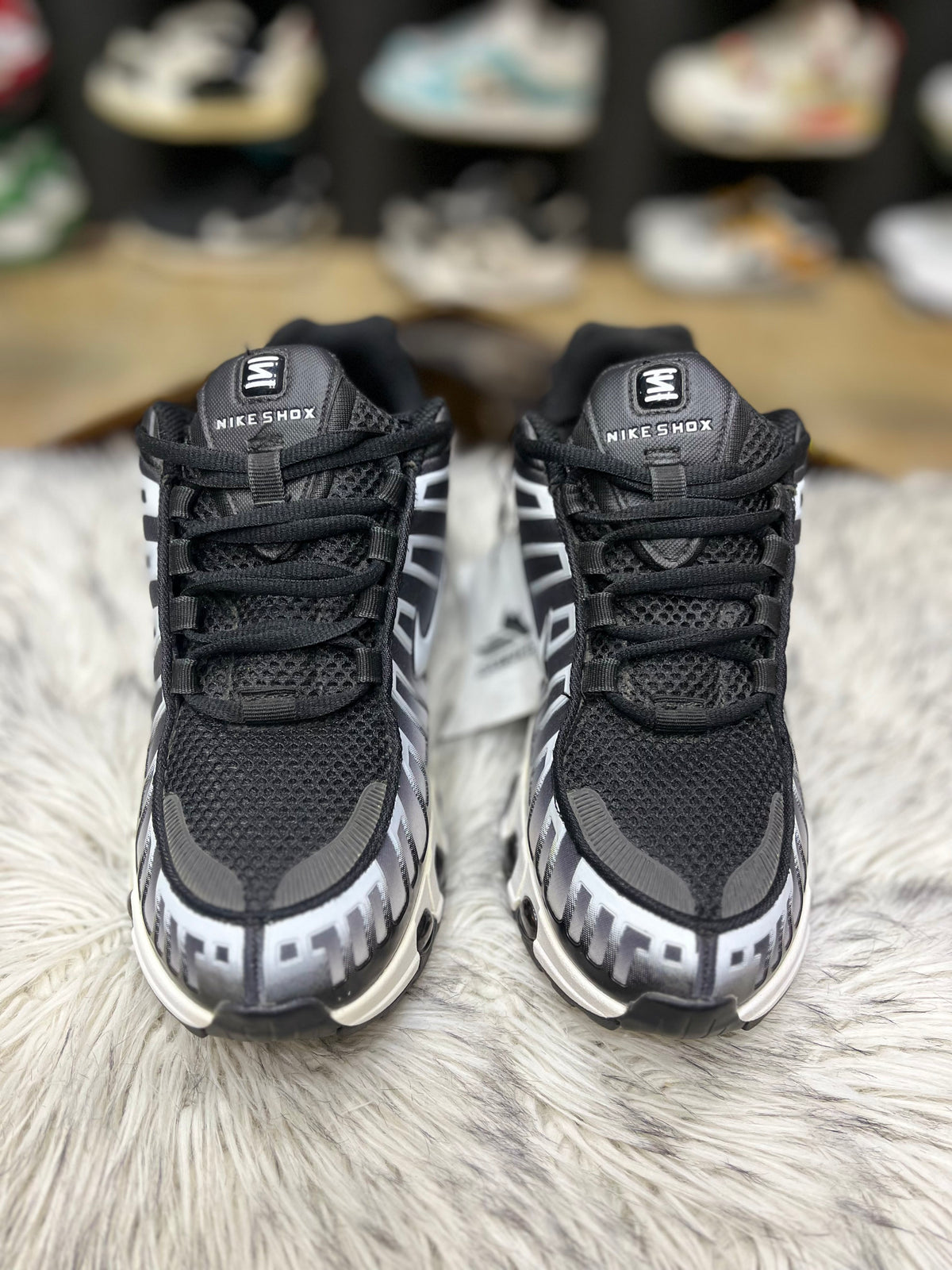 Black and white Nike sneaker with a mesh and synthetic.